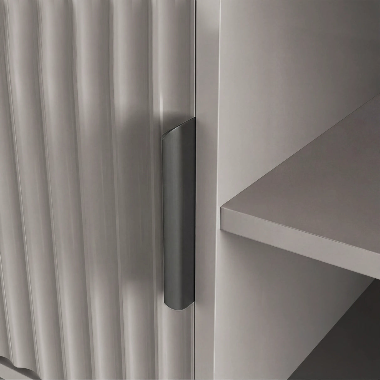 Grey modern TV stand with vertical fluted doors and grey handle, styled for a contemporary living room centerpiece.