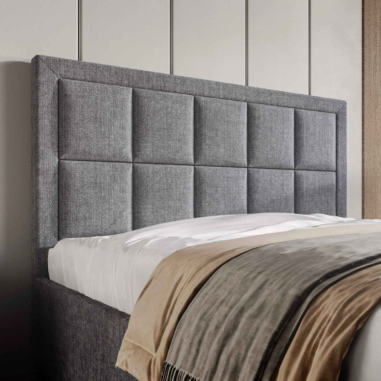 Gray upholstered headboard with a bed in a bedroom setting
