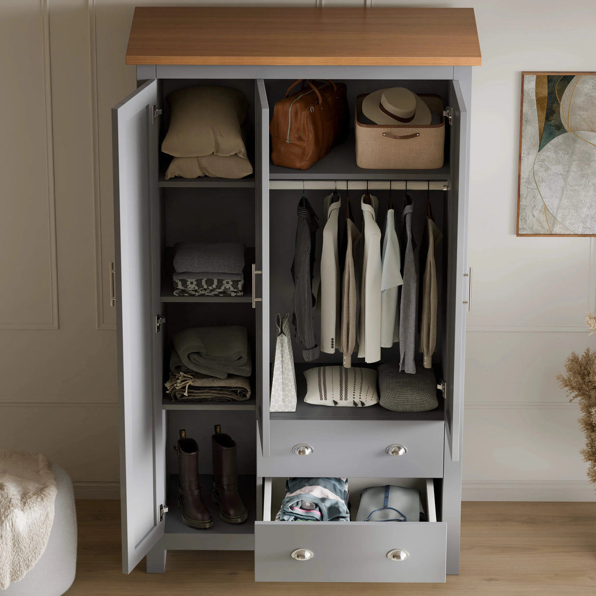 interior of grey shaker triple wardrobe with drawers, shelves, and hanging rail, offering organised storage space