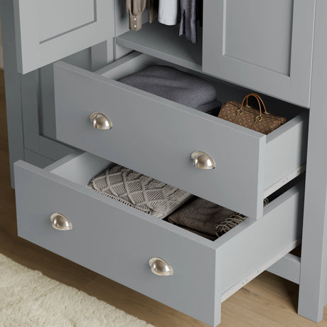close-up of grey shaker wardrobe drawers with brushed metal handles, showing deep storage for clothes and accessories