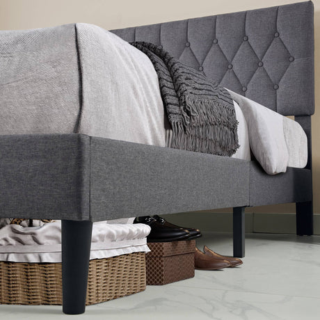 Under-bed storage space of the Linen Grey Bed Frame, showing clearance for baskets and shoes on a tiled floor.