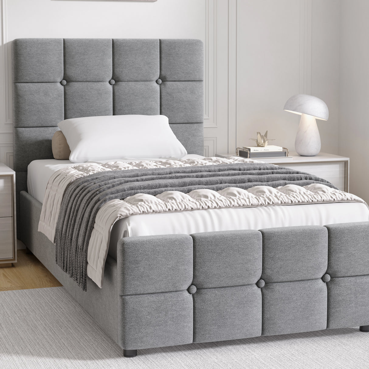 Gray upholstered bed with tufted headboard in a bedroom setting