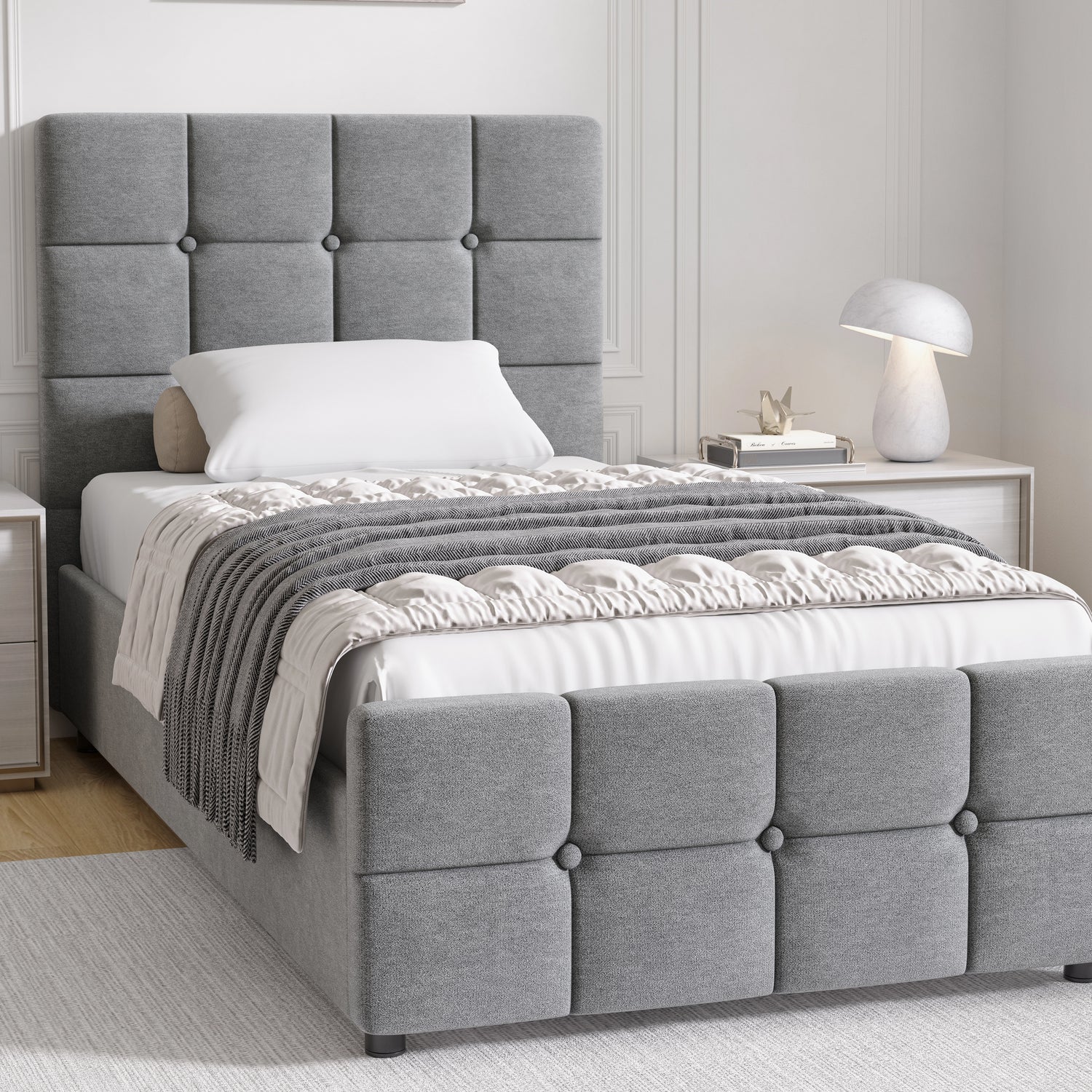 Gray upholstered bed with tufted headboard in a bedroom setting