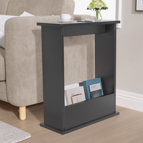 Gray side table with books and a vase in a living room setting