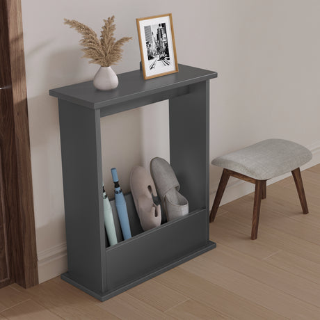 Gray shoe rack with shoes, umbrella, and decorative items against a neutral wall.