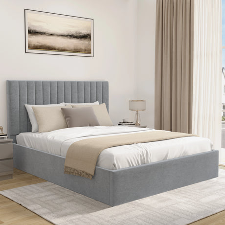 Modern bedroom with a grey upholstered bed, beige throw blanket, and abstract art on the wall.