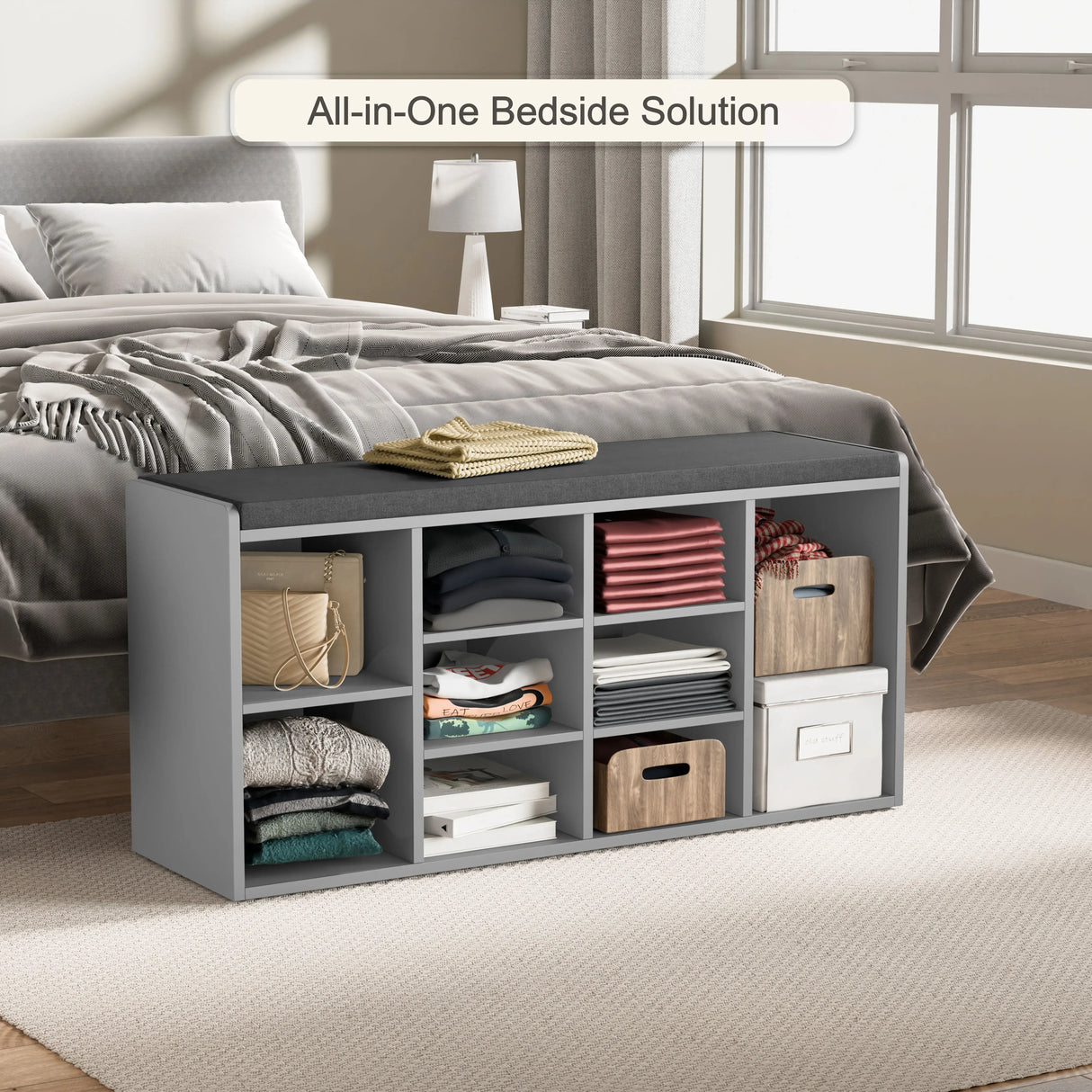 Hallway shoe storage bench with cushion & adjustable shelves in grey, placed at the foot of a bed, used for organizing clothes and accessories.
