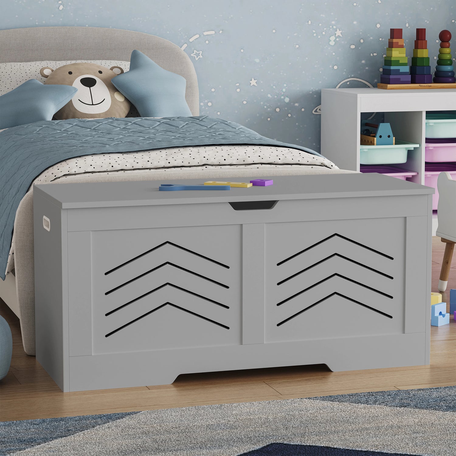 Gray toy storage box with chevron pattern in a child's bedroom.