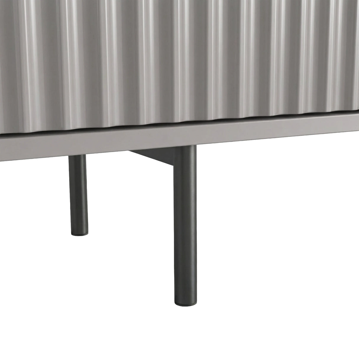 Grey TV unit with slim metal legs and fluted doors, showing an elevated modern design for a living room.