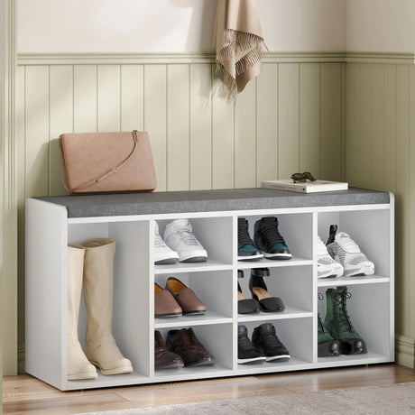 Hallway shoe bench storage with cushion and adjustable shelves in white, featuring multiple compartments for organized footwear storage in entryway.