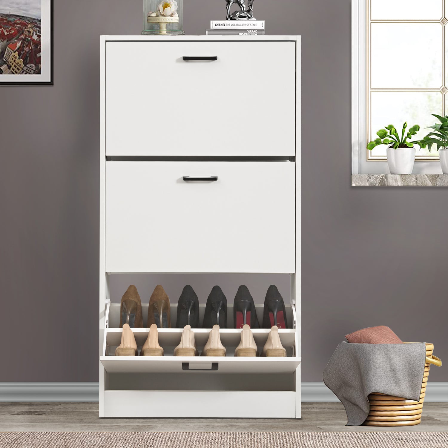 Shoe storage cabinet shown from a front angle, with the bottom drawer open to reveal 6 pairs of shoes.