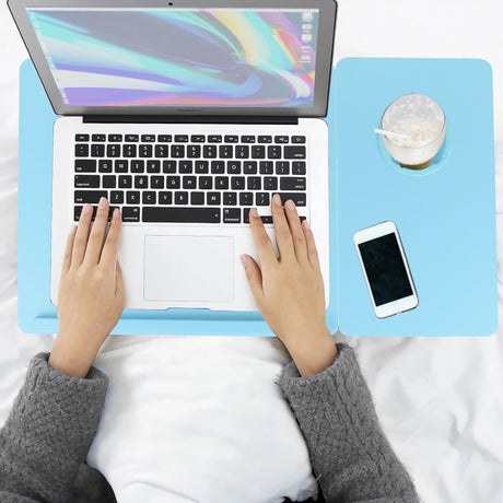 top view of hands using a blue sofa laptop table with a standard laptop on its raised surface