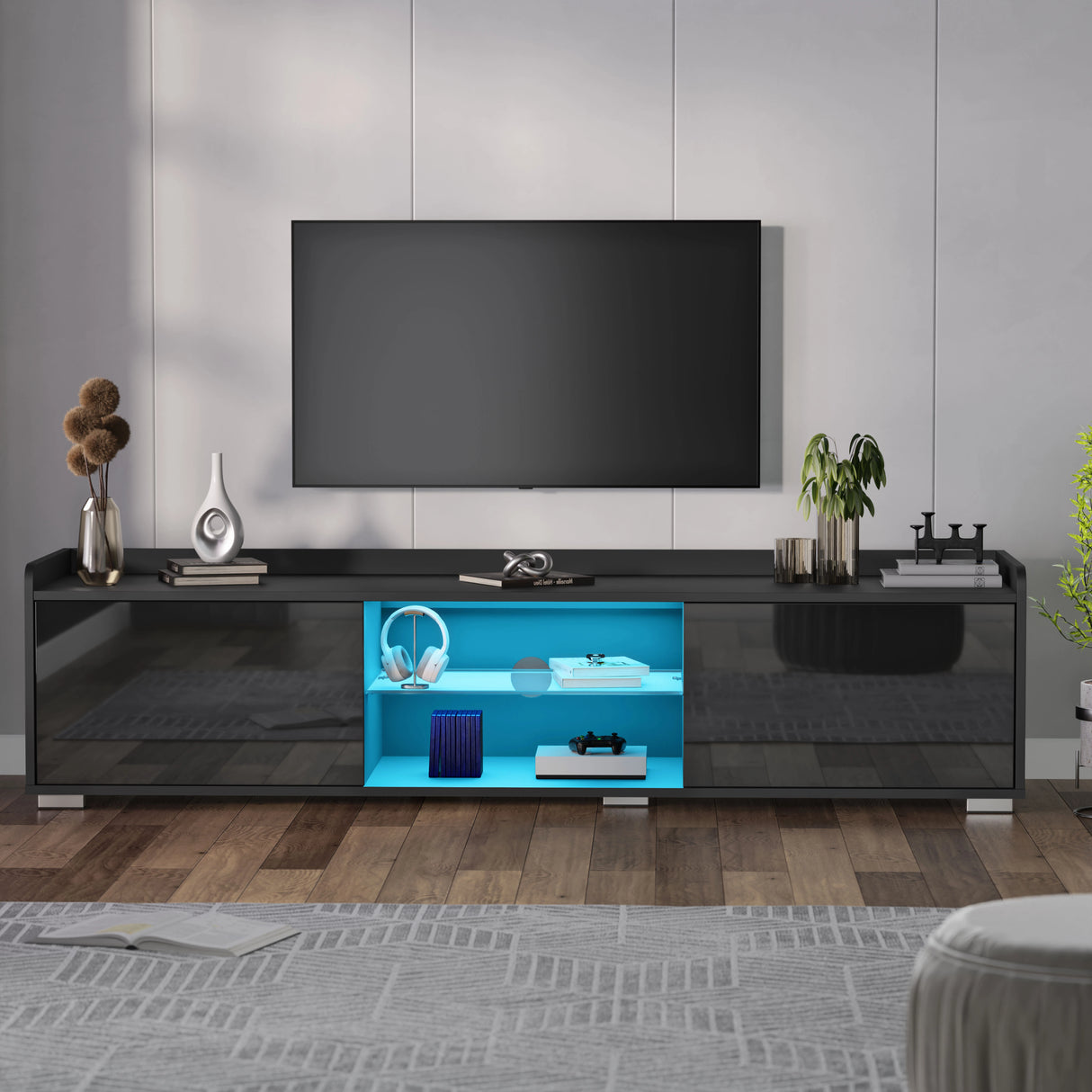 Modern black TV stand with a blue interior in a living room setting.