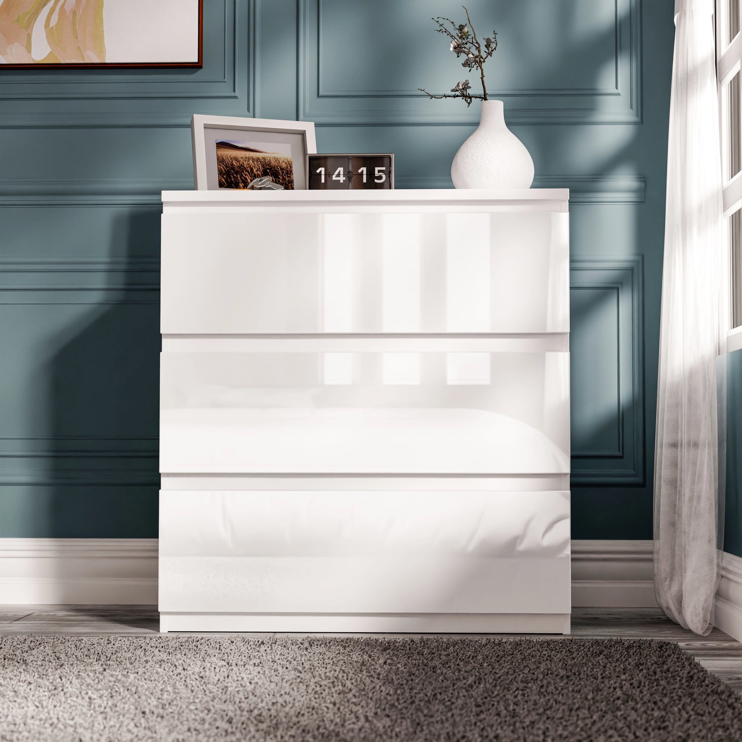 High Gloss 3 Drawer Chest of Drawers in white with handleless design, placed in a modern bedroom with blue panel walls and decor.