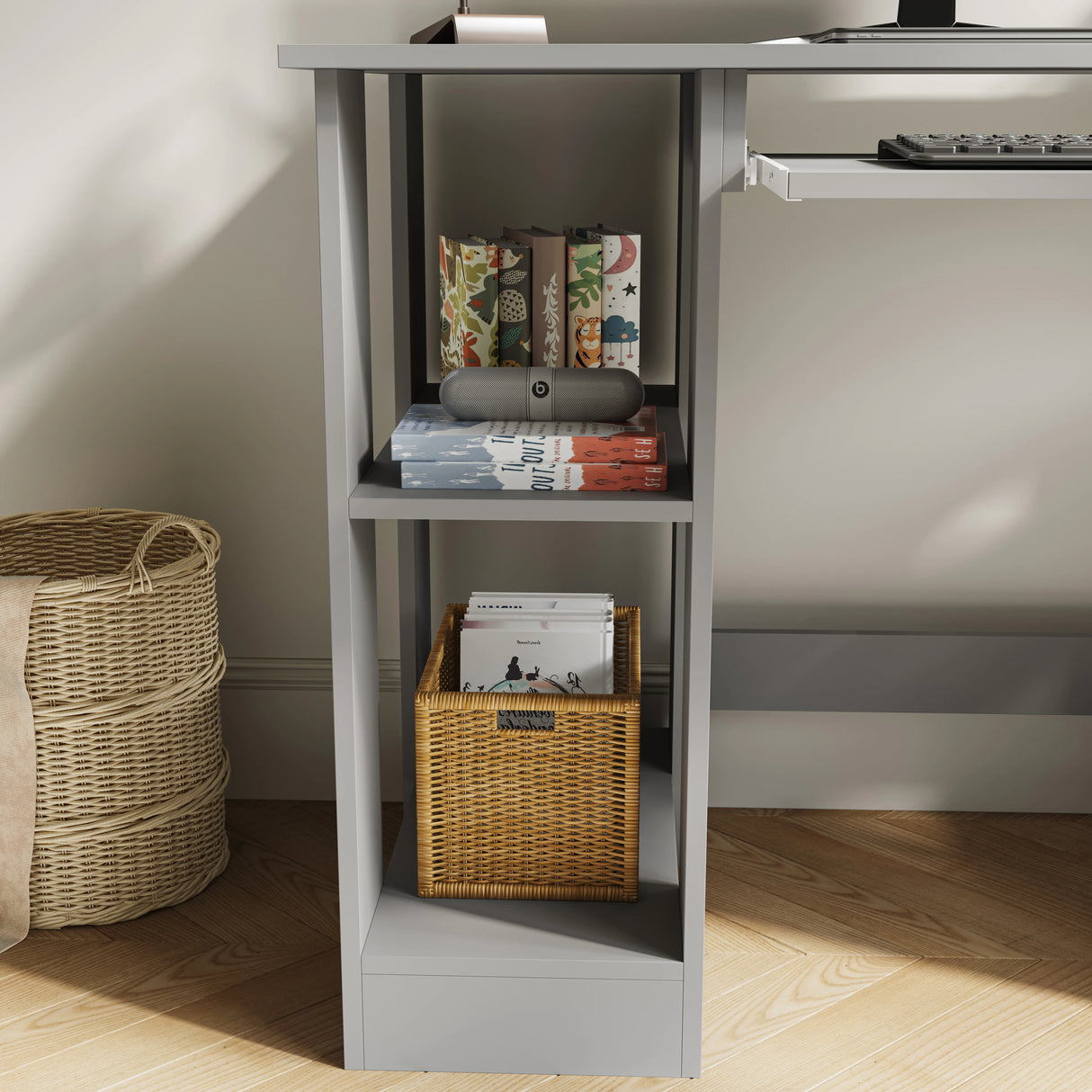 Side shelf view of Home Office Computer Desk With Shelves For Working, Reading & Gaming in grey, showing books, storage basket, and decorative items.