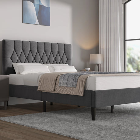 Grey velvet bed frame in king size with adjustable chesterfield headboard, set in modern bedroom with wooden flooring and neutral decor.