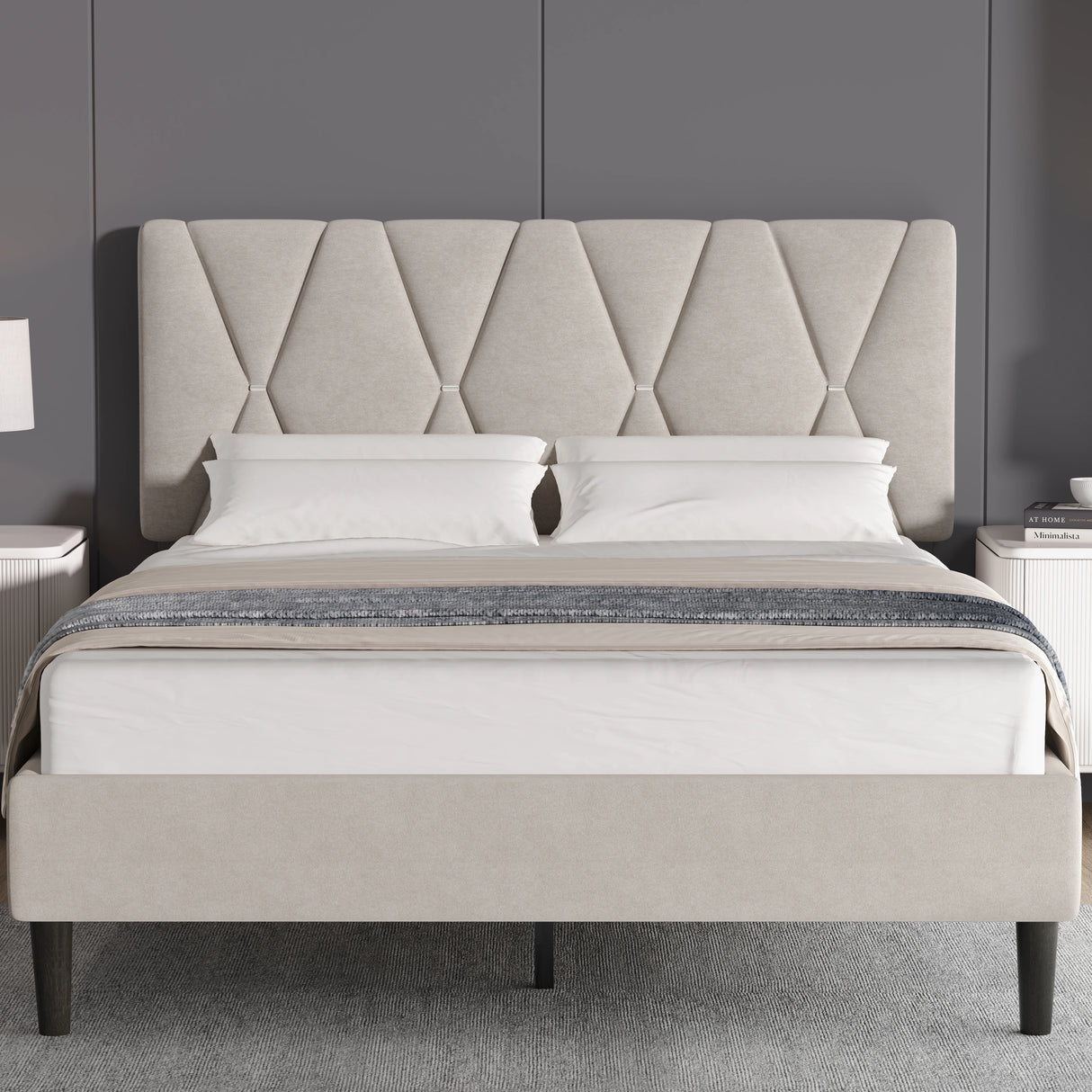 Beige upholstered bed with diamond patterned headboard in a room setting.