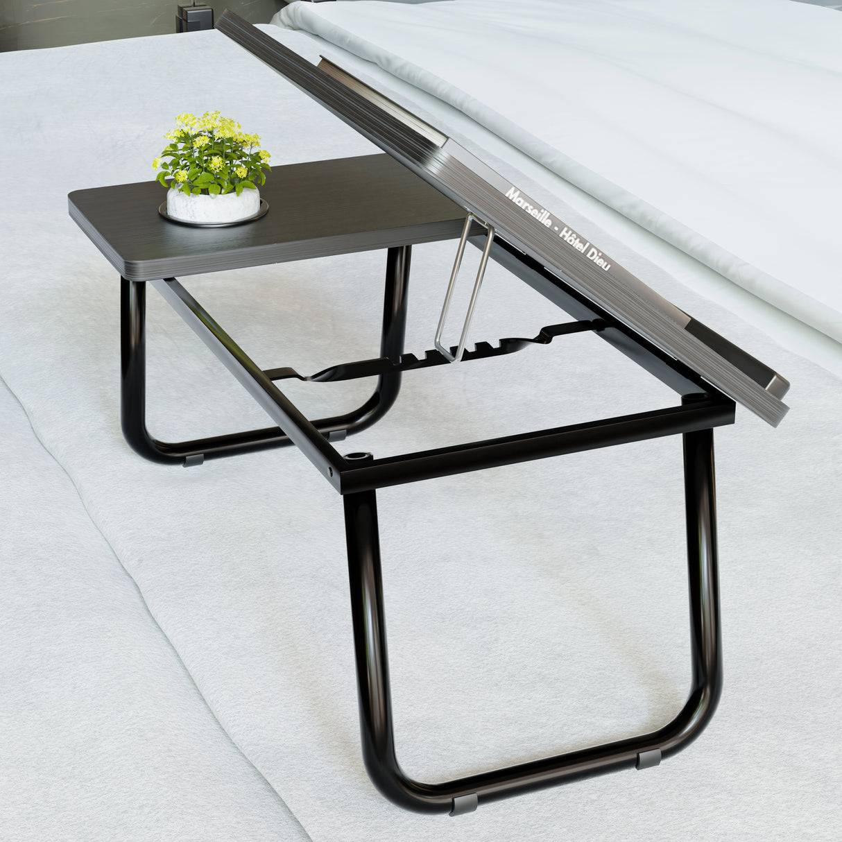 Portable folding laptop desk with height adjustable top and built-in cup holder, ideal for bed or floor use. Sleek black design with sturdy legs.