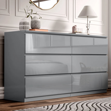 Gray high-gloss dresser with decorative items in a bedroom setting