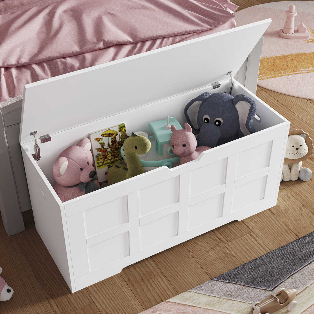 White Shaker style storage chest with lid and safety hinges, used as a toy box in a child's bedroom with plush toys and books inside.