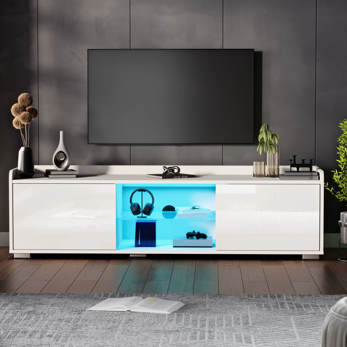 Modern living room with a white entertainment console, TV, and decorative items.