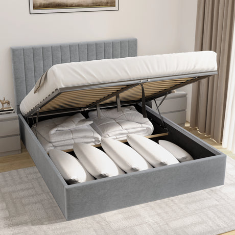 Grey upholstered bed with storage drawers open in a bedroom setting