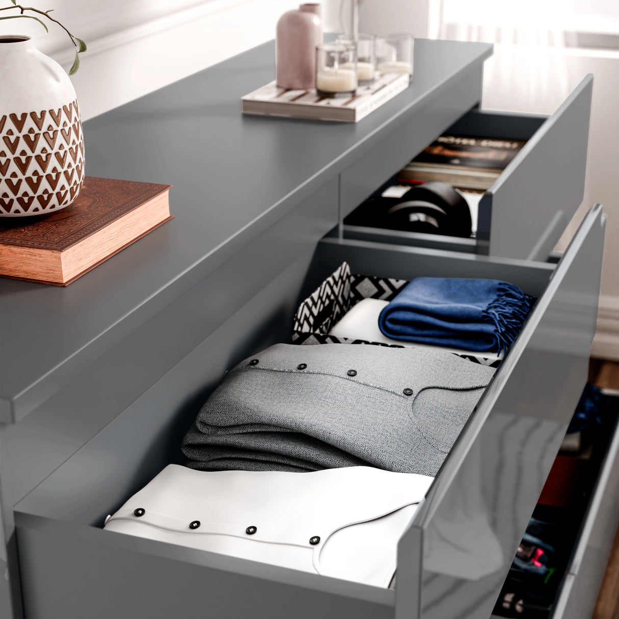 High Gloss Large 6 Drawer Chest of Drawers in dark grey with open drawers showing neatly folded clothes and accessories. Ideal for modern bedroom storage.