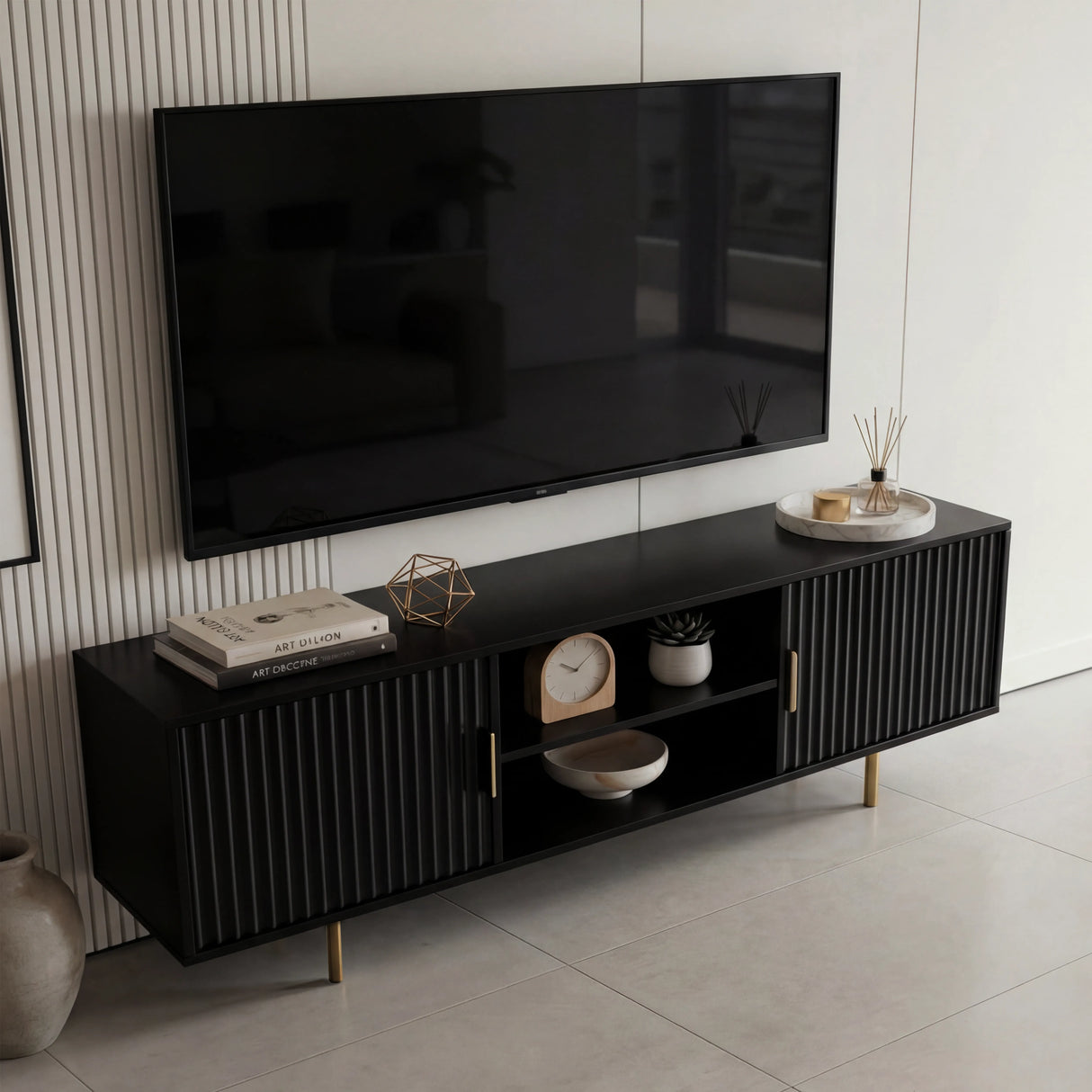 Long black TV unit with a wide top surface and fluted cabinets, ideal for large screens and modern living room storage.