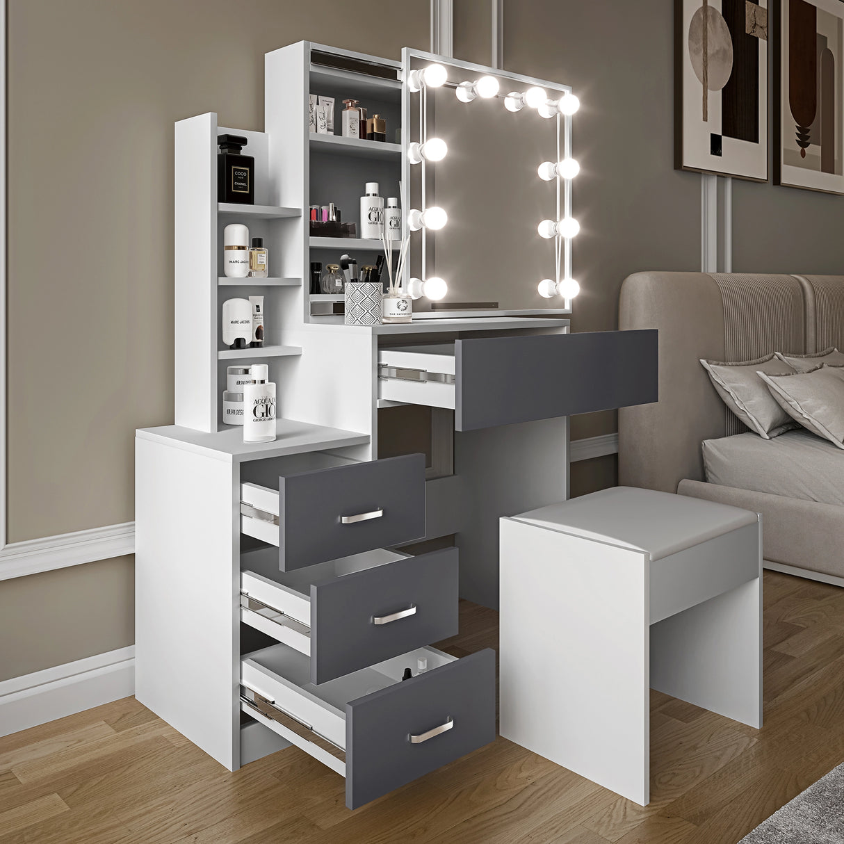 Angled view of makeup vanity with mirror and lights placed near a bed in modern room setting