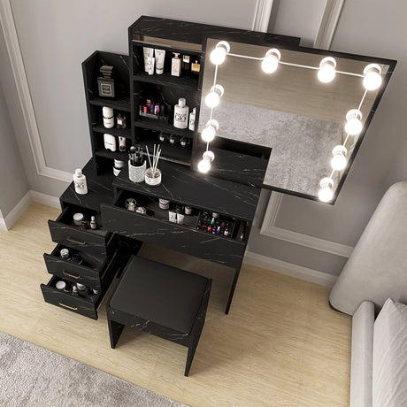 Black marble makeup vanity with mirror and lights in a room setting.