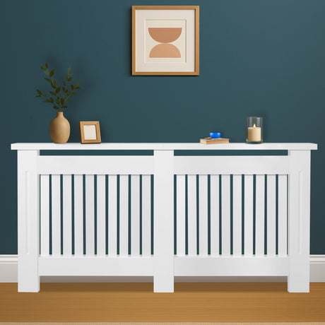 White radiator cover with decorative items against a blue wall