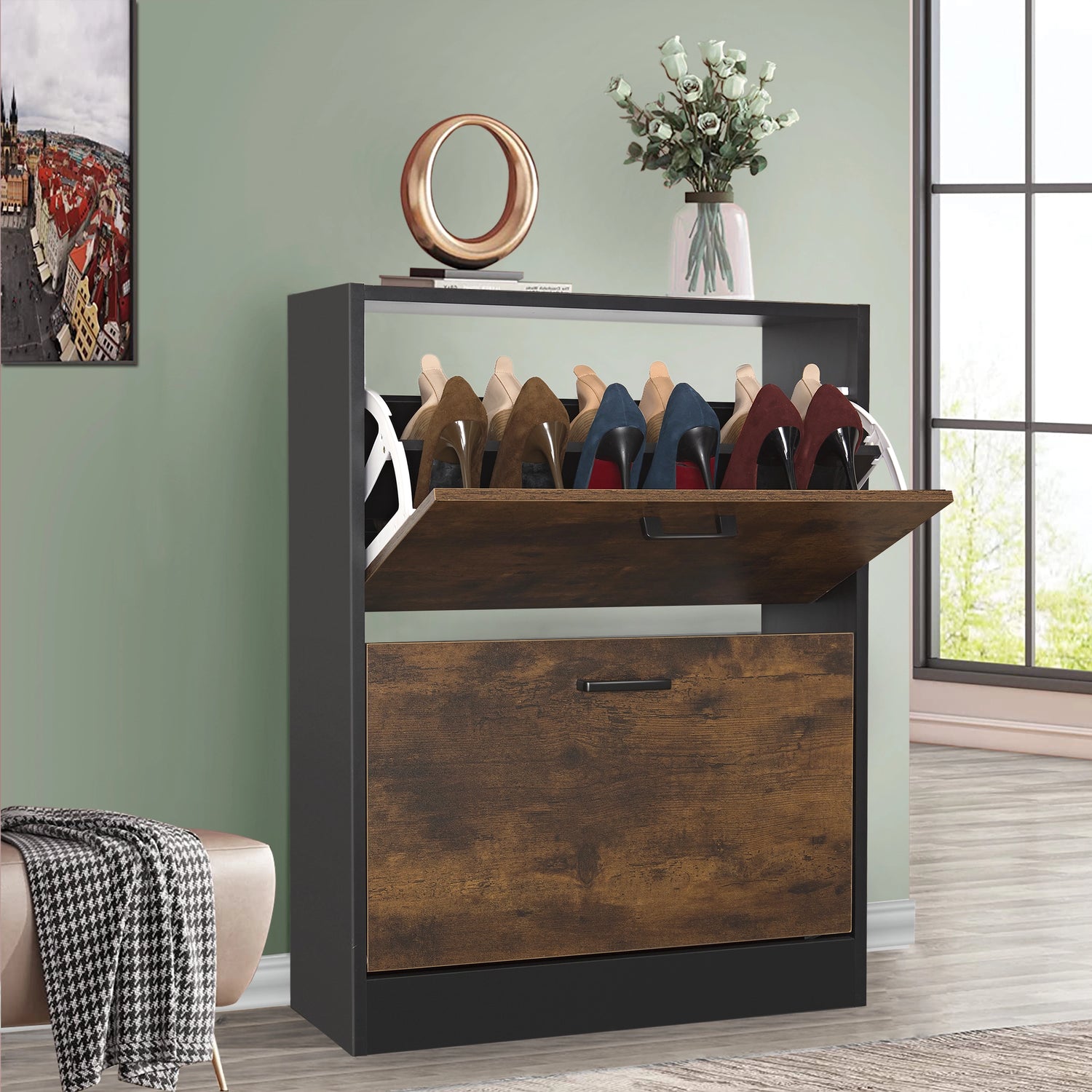 Rustic shoe storage cabinet in black with top pull-down drawer open and a potted plant styled on the surface.
