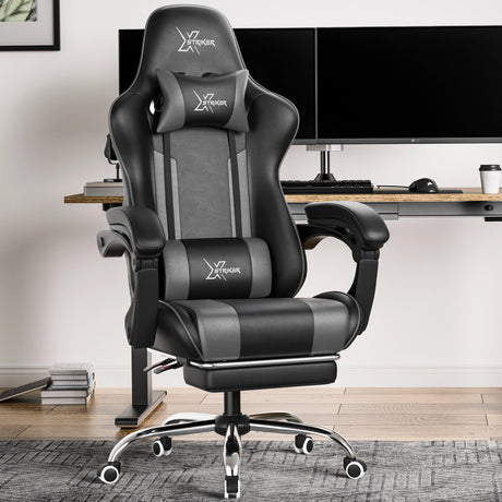 Xstriker Gaming Chair With Footrest in black and grey, featuring ergonomic lumbar support and headrest, placed in a modern home office setup.
