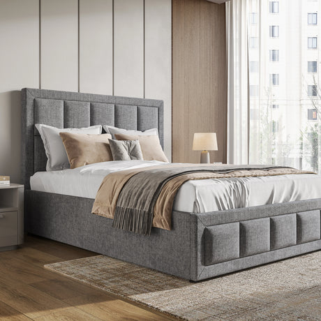Gray upholstered bed with pillows and a blanket in a modern bedroom setting.