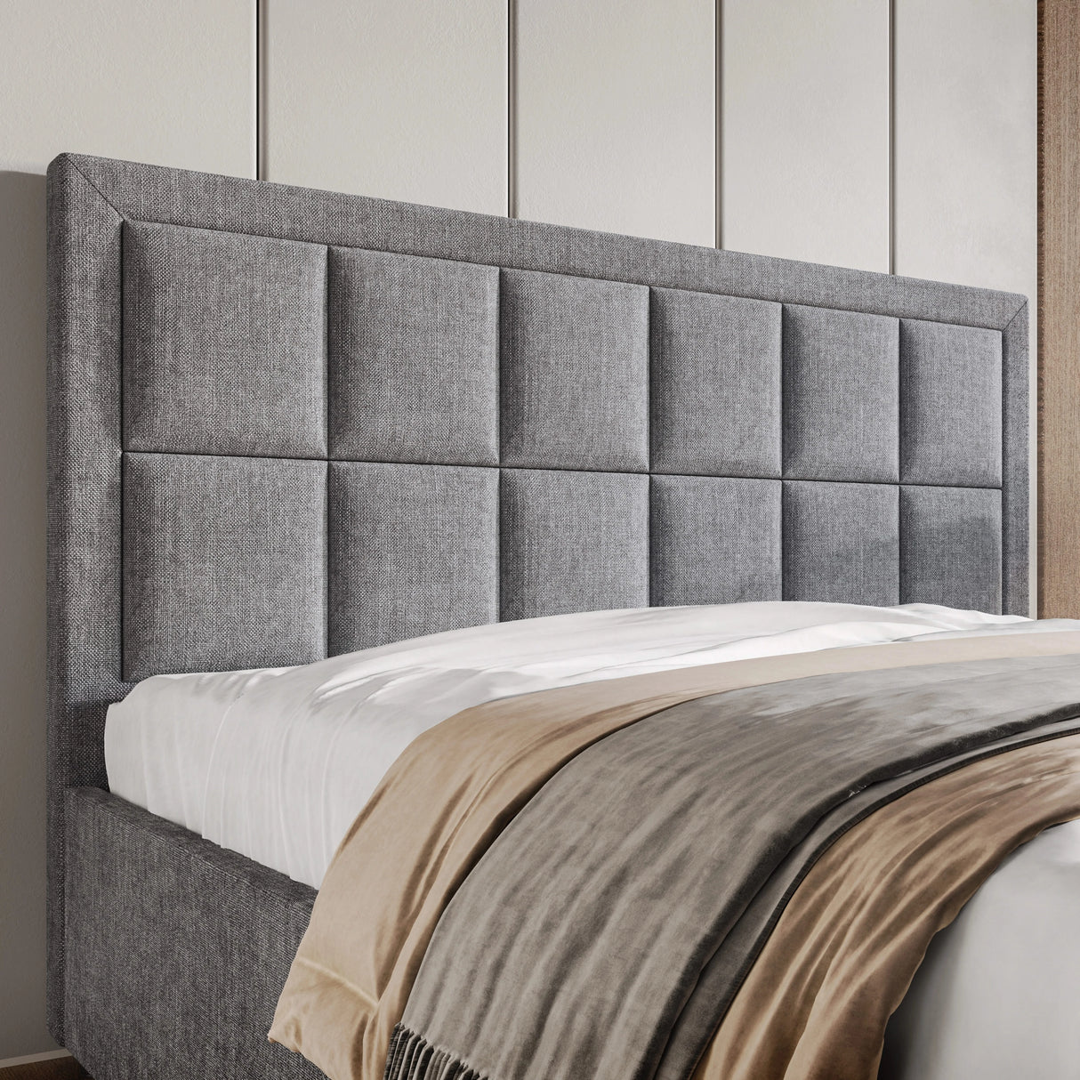 Gray upholstered headboard with a bed in a room setting