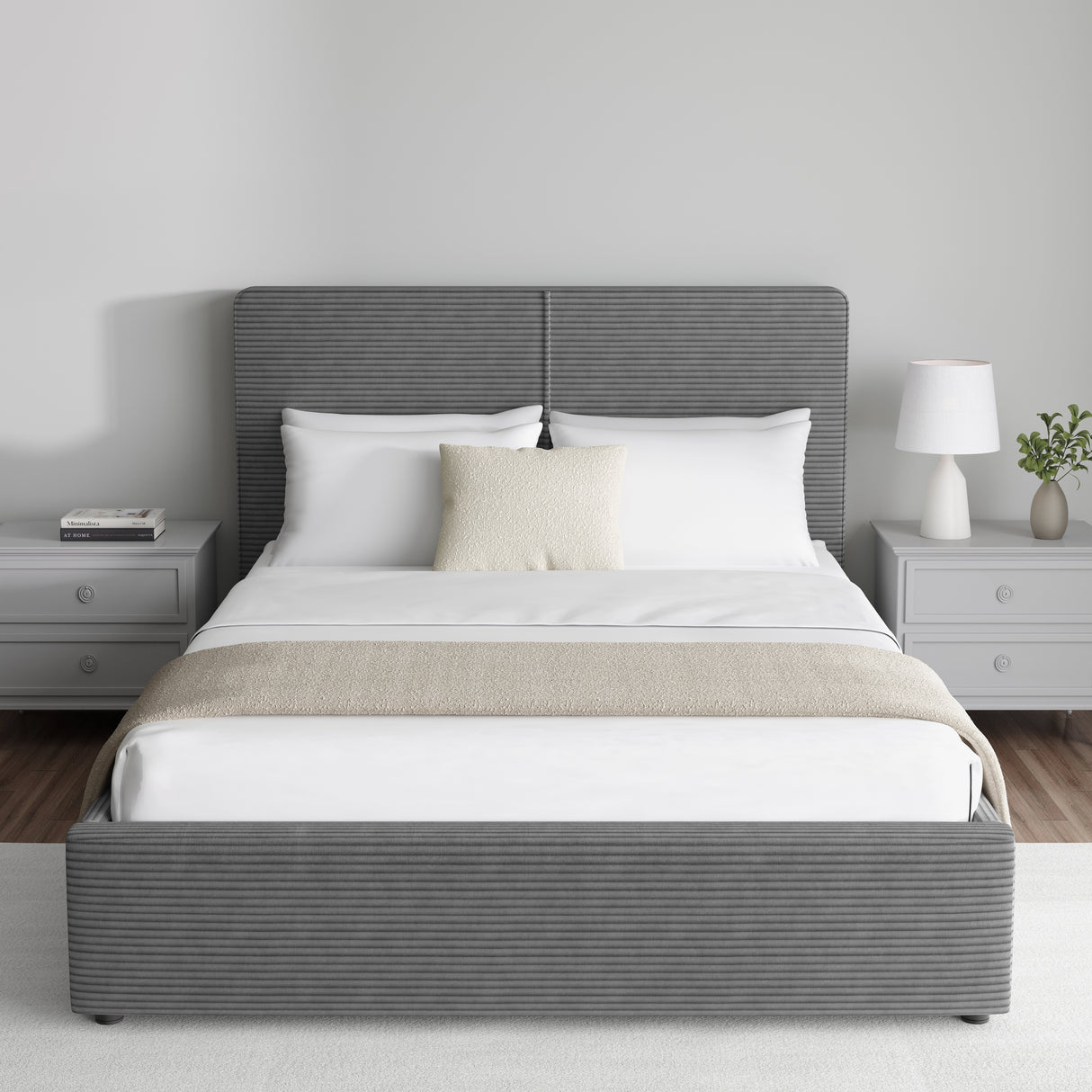 Corduroy ribbed velvet upholstered ottoman bed frame with storage in dark grey, shown in a modern bedroom with matching grey nightstands. Features a lift-up storage base and padded headboard.