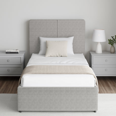 Corduroy ribbed velvet upholstered ottoman bed frame with storage in light grey, shown in single size with matching grey nightstands. Ideal for modern bedrooms.