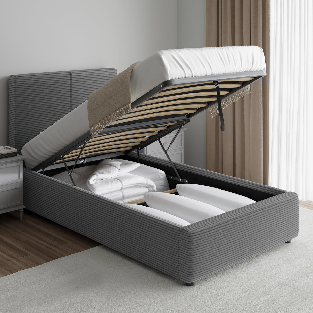 Corduroy ribbed velvet upholstered ottoman bed frame with end lift storage in dark grey, shown with mattress lifted to reveal bedding storage space.