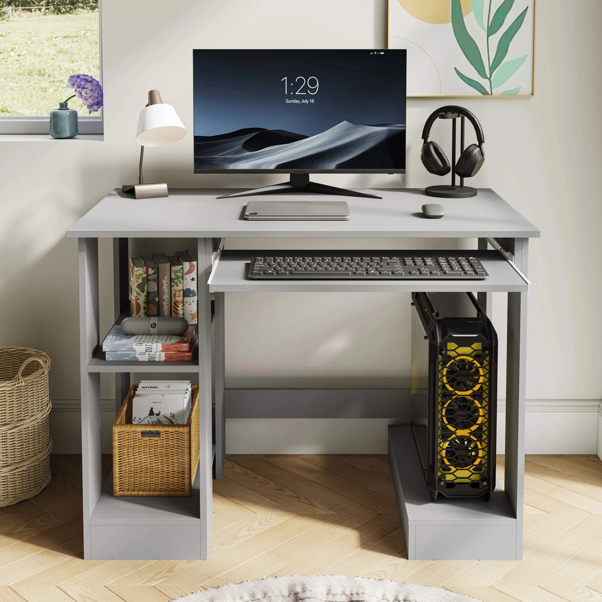 Home office computer desk with shelves in grey, featuring a keyboard tray, monitor, and organized storage for books and PC tower. Ideal for compact workspaces.
