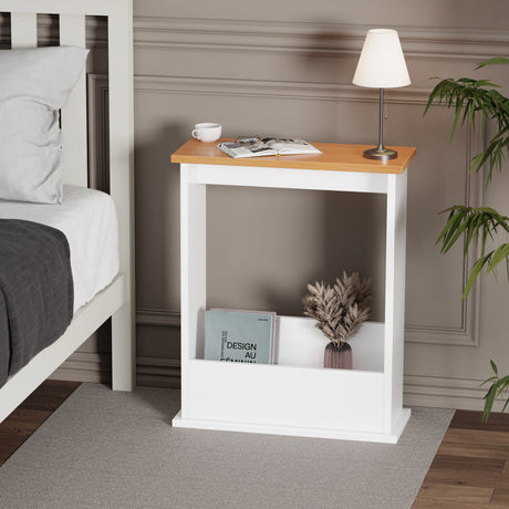 slim side table with oak top used as nightstand, lamp and books on top, shown in cozy bedroom