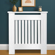 White radiator cover with decorative items on a blue wall