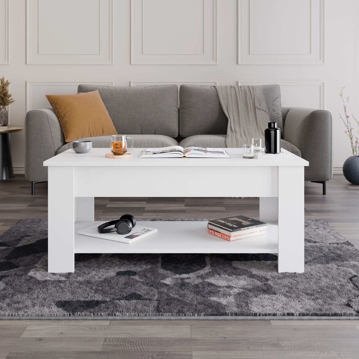 Lift top coffee table with storage in white finish, 100cm wide, placed in modern living room with grey sofa and rug. Ideal for compact spaces.