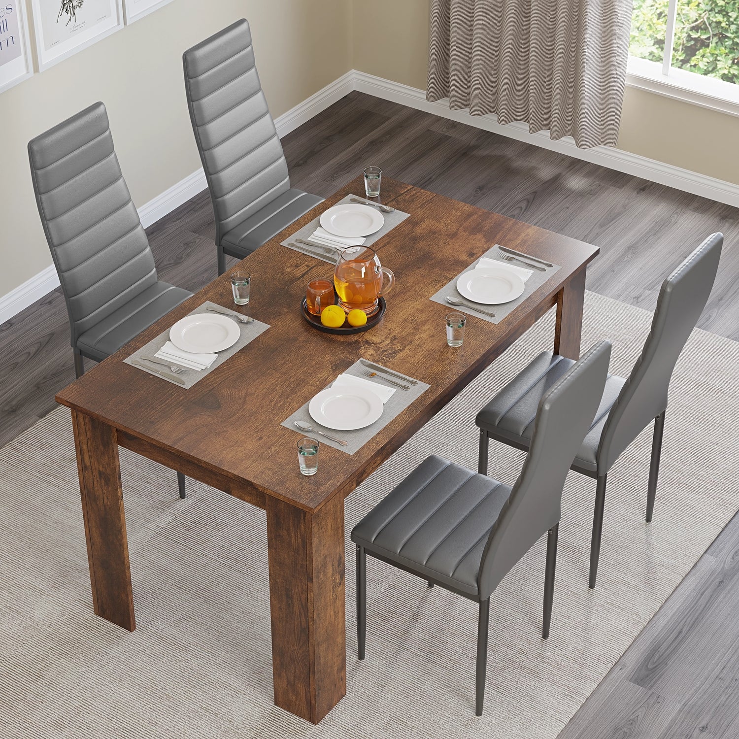 top-down view of a small dining table set with grey chairs and four plate settings, ideal for cozy dining rooms