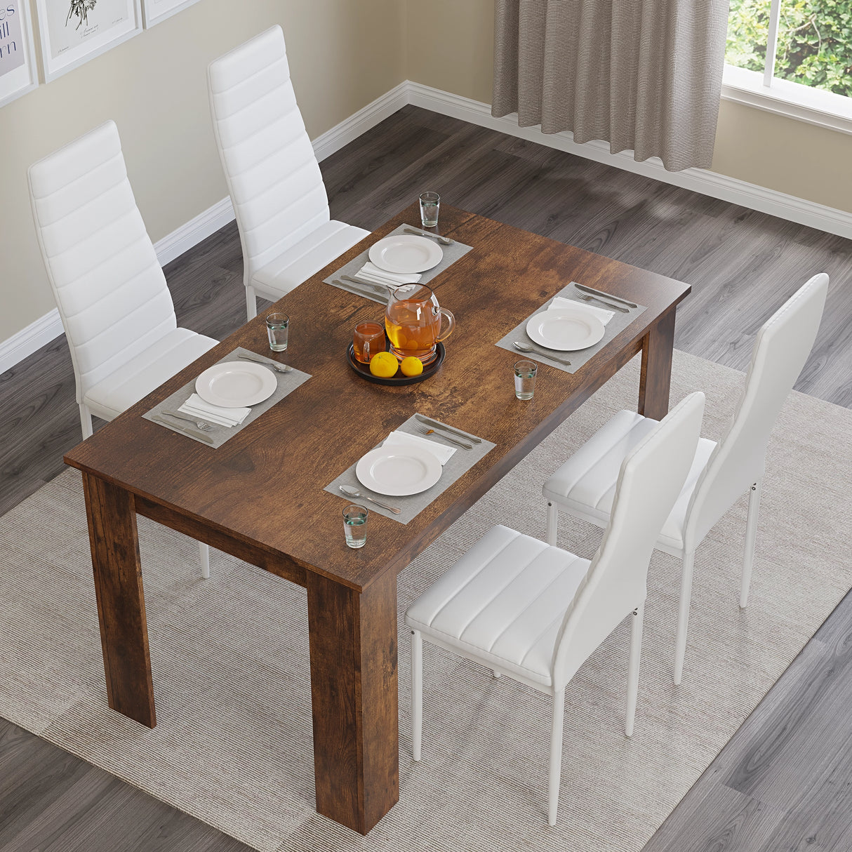 top-down angle of rustic kitchen table and chairs set with white seating and four place settings for everyday dining