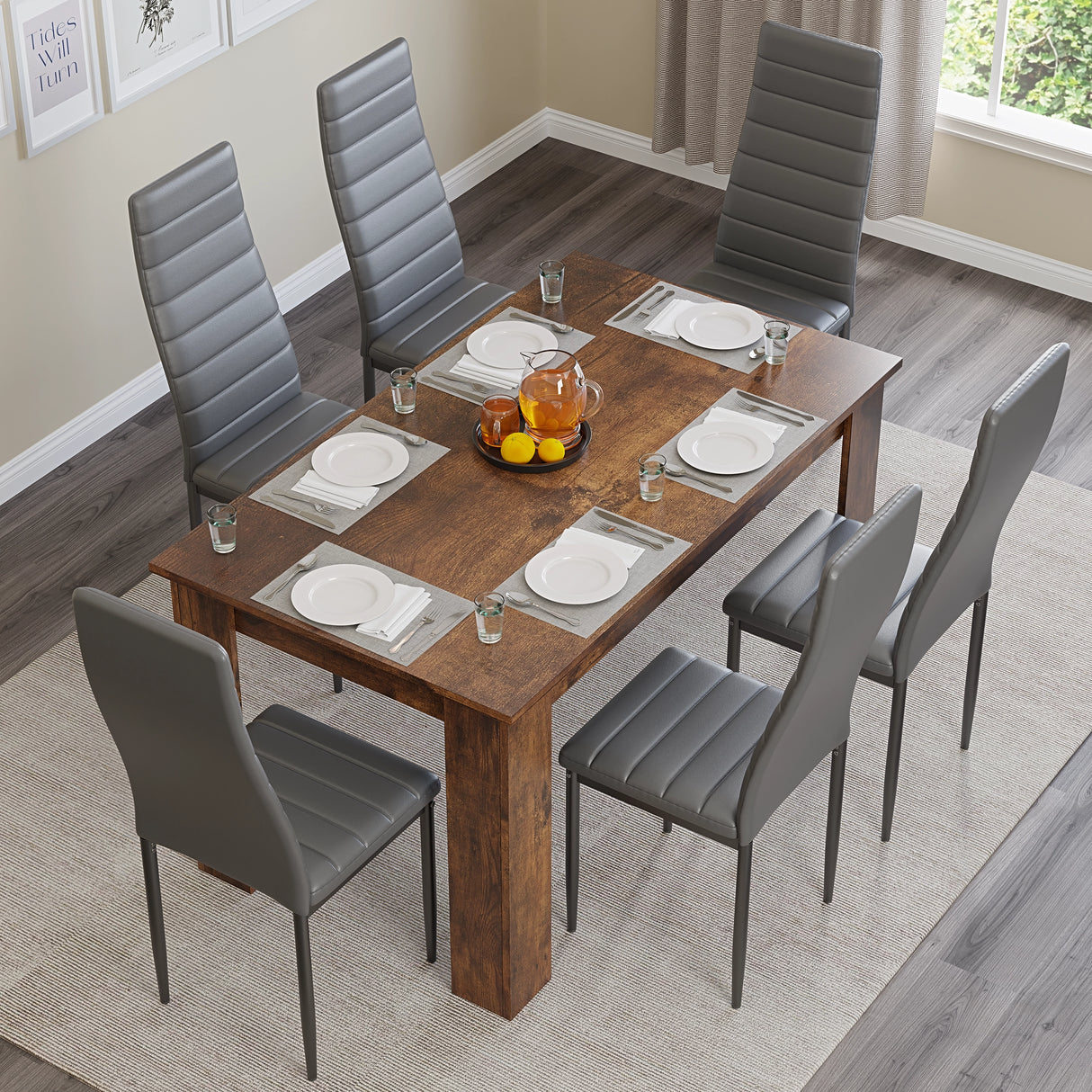 top-down view of dining table and 6 chairs in grey, set with 4 dining plates and a centerpiece in a well-lit dining area