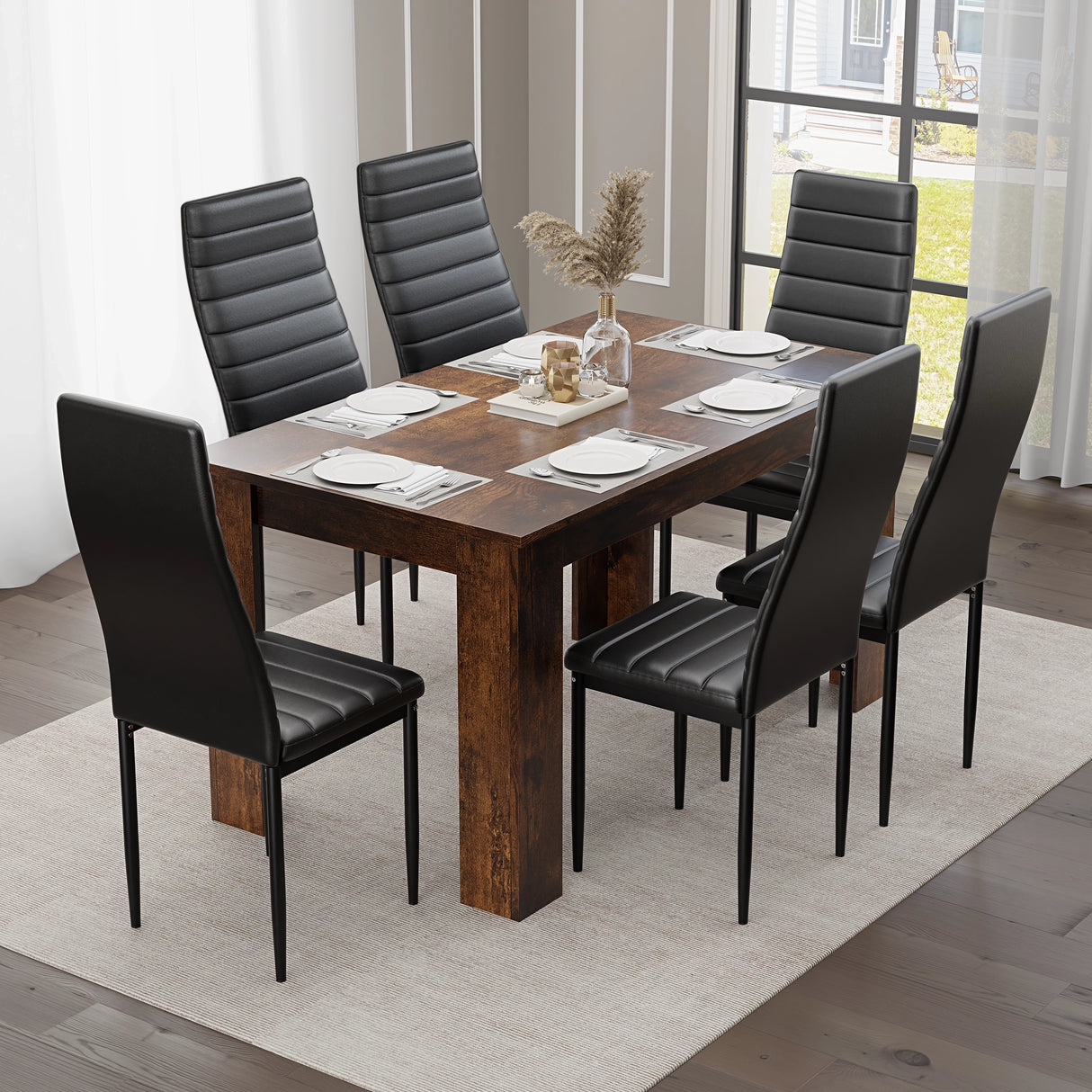 rustic dining table and 6 chairs shown from above with black cushioned seating and six full place settings