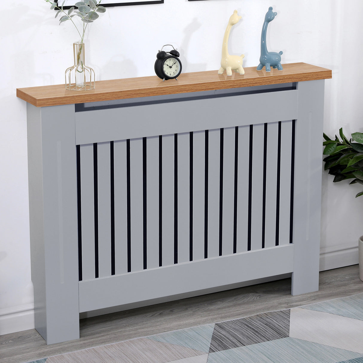 Medium grey radiator cover with oak top displayed in a cozy living room, combining safety and modern charm.
