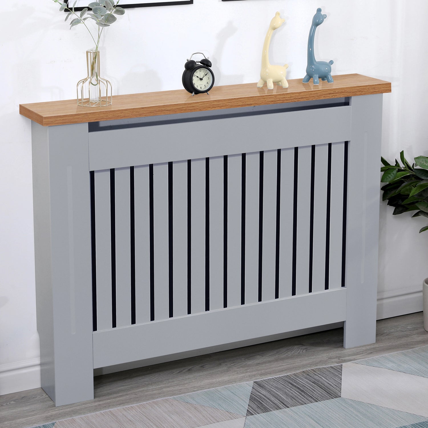 Medium grey radiator cover with oak top displayed in a cozy living room, combining safety and modern charm.