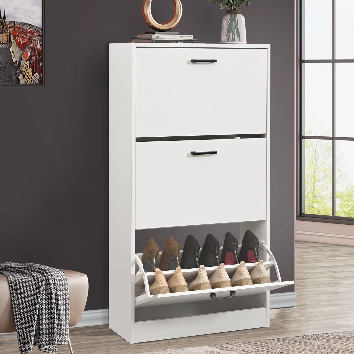 White shoe cabinet featuring a 3 tier shoe cabinet design, showing footwear stored in the lowest pull-down drawer.