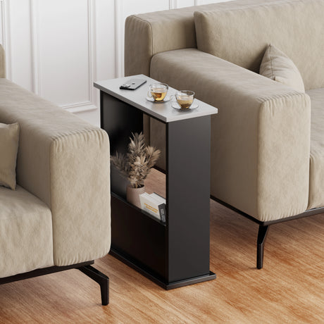 side table for sofa shown between two sofas, black base and silver grey top with magazine inside